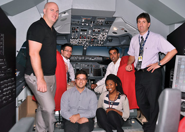 From left to right: In the cockpit: Stephen Jacobs and Sandeep Sandhu; seated: Anthony Rubino and Terri-Anne Cambridge; standing: Jean-François Aubin and Richard Gauthier. | Photo by Marc Bourcier