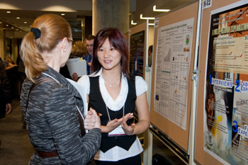 Samie Li Shang Ly, 2010 winner in the MSc category, discusses her research with one of the judges. | Photo by Photographie KLM