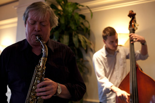 Music professor Dave Turner plays sax while student Philippe Caron-Turbide accompanies him on bass.
