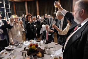 Glasses raised to Concordia President and Vice-Chancellor Frederick Lowy and Mary Kay Lowy.