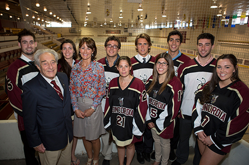 Frederick Lowy and Kathleen Weil pose inside the arena with members of the men's and women's Concordia hockey teams | Photo by Concordia University