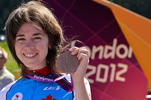 Cyclist Marie-Claude Molnar proudly displays her women’s individual road race bronze medal. | Photo by Phillip MacCallum/Canadian Paralympic Committee