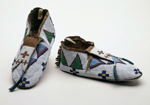 Moccasin. Anonymous. Northern Plains, Aboriginal: Nehiyaw, 1920, 20th century. Tanned and smoked hide, glass beads, horsehair, tin-plated iron cones, pigment, sinew, cotton thread. Gift of the Art Association of Montreal. © McCord Museum