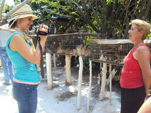 Melanie Gallant, GrDip 08, interviews a rabbit farmer on assignment for Oxfam Canada in Cuba. | Photo courtesy of Oxfam Canada
