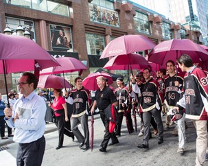 Dean of Students Andrew Woodall (at left) and men’s hockey coach Kevin Figsby (with the black and red jacket over his arm) lead the men’s hockey team in the annual March of the Umbrellas, the kick-off to the Centraide of Greater Montreal campaign on October 1.