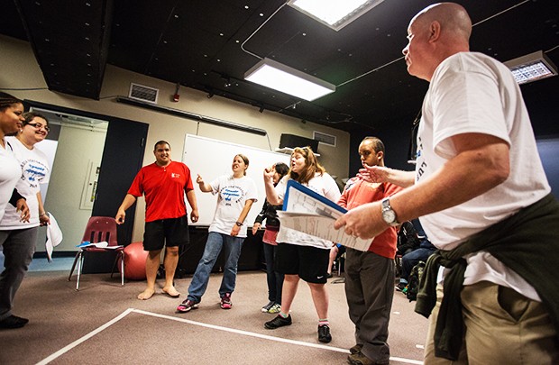 Creative Arts Therapies professor Stephen Snow (right) leads the performers through a rehearsal of The Amazing Adventures of Relationships. 