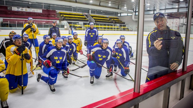 Swedish team members listen to head coach Rikard Grönborg