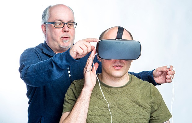 Industrial engineering graduate student Noah Saber-Freedman tries out a Samsung Gear VR headset, owned by Concordia alum Warren Wilansky (standing): “It’s the real deal.”