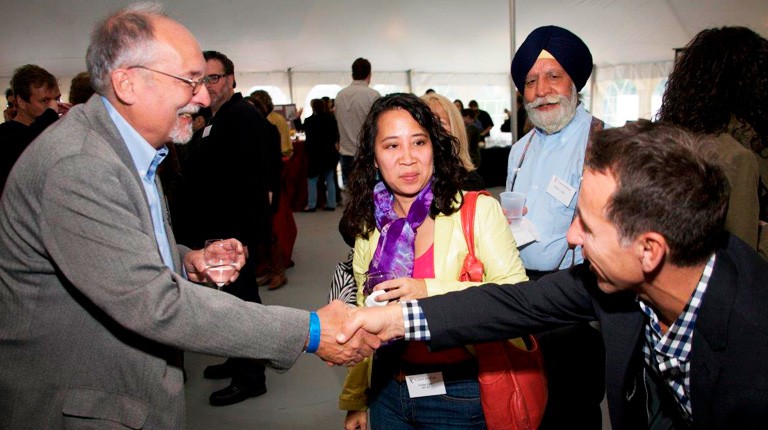 Murphy (left) welcomes alumni to the Communication Studies 45th anniversary reunion on the Loyola Campus in 2010. 