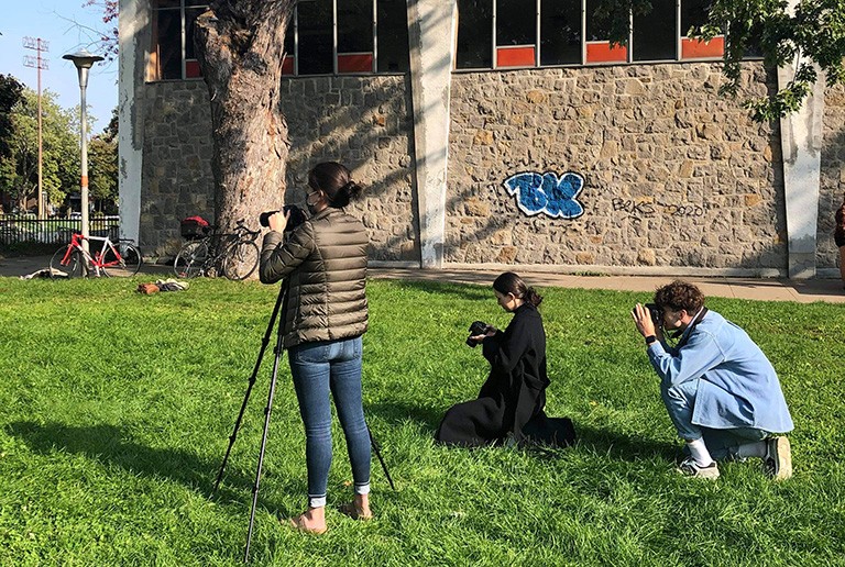 Concordia’s new student club, In-Focus Media. Three people, each with a camera, taking a photo of someone outside the picture frame.