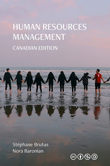 Image of the cover of a book, with a group of people standing ankle-deep in the ocean and holding hands.
