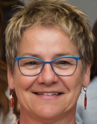 Guylaine Vaillancourt Middle-aged woman with short blonde hair and blue-rimmed glasses.