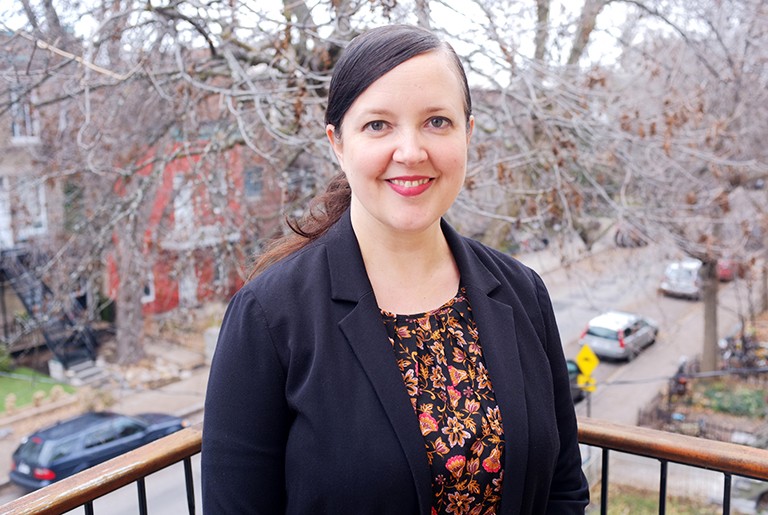 Katherine McLeod: “When we think of the library, an image of books comes to mind. In fact, there are so many audiovisual materials in the general collection.” Young woman, smiling, with red lipstick, long dark hair, and a blue suit jacket.