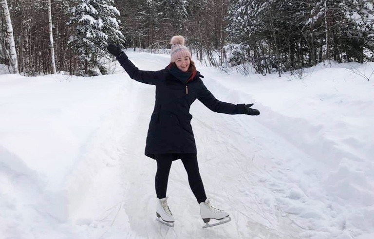 “If you’re in Montreal, why not try ice skating, snowshoeing or tobogganing in parks?” Young woman in ice skates on a frozen creek.