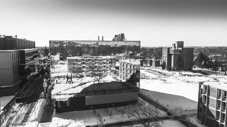 Black and white photo of a university campus in winter.