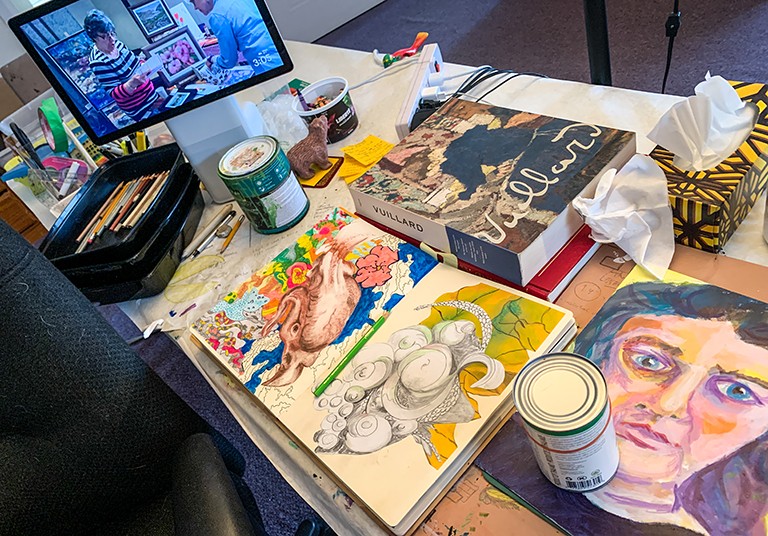 All photos by Lisa Graves and courtesy of the artists. Artwork, art materials and a laptop on a table.