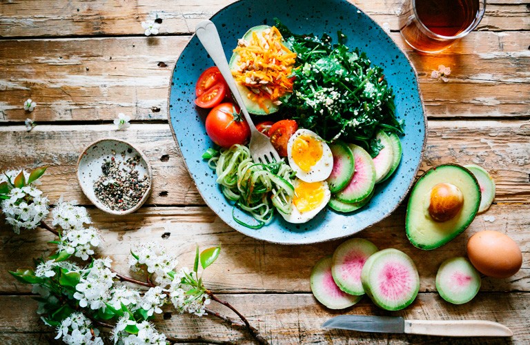 A plate of food set out on a wooden table.