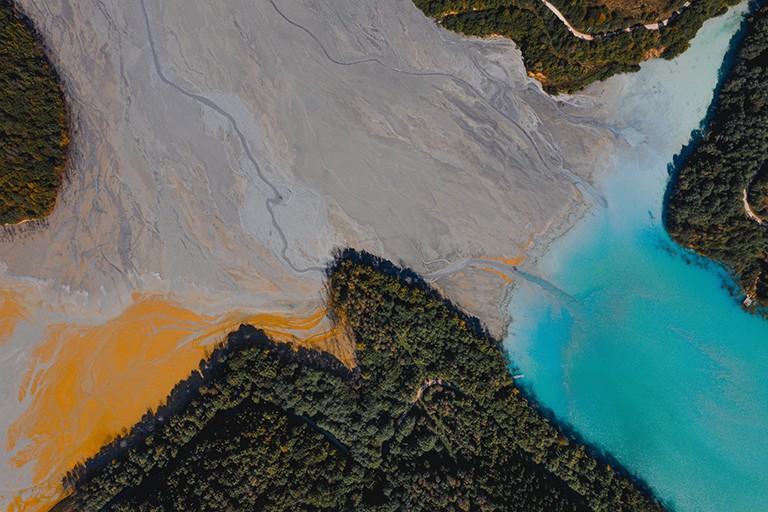 Pictured: A waste lake in Romania — the polluted water ways are grey, ochre and turquoise.