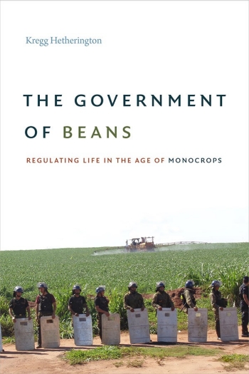 Image of the cover of a book with police standing in front of a crop field in riot gear.