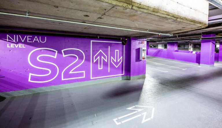 Underground parking lot with vibrant purple walls