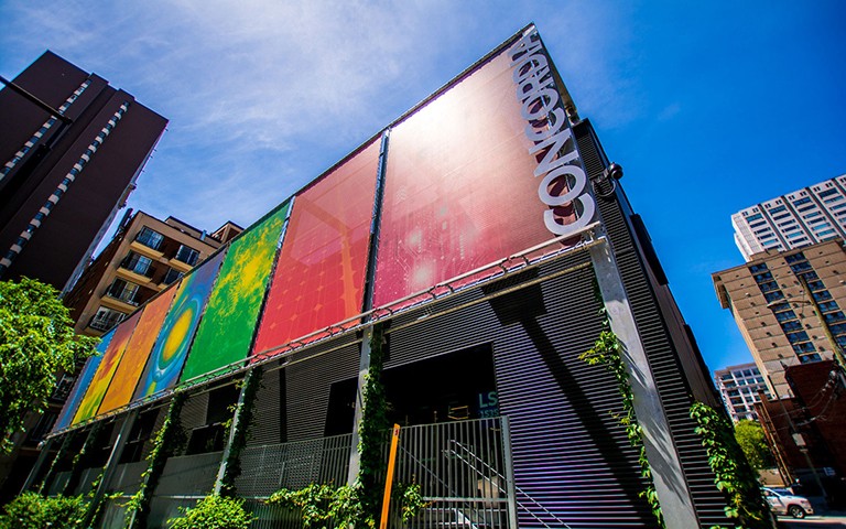 A colourful building downtown with a sign on the side that says, "Concordia"