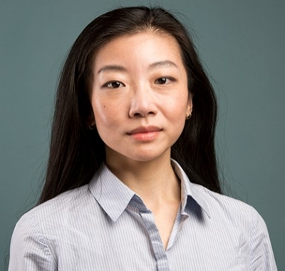 Young woman with long, dark hair and a dress shirt