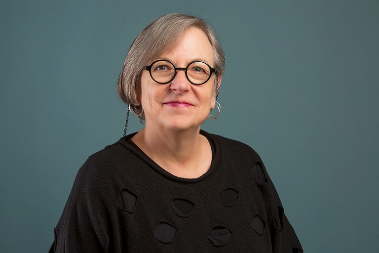 Varda Mann-Feder: “There is a significant degree of territorial injustice in relation to entitlements for youth leaving care.” Smiling woman with black-rimmed glasses, a bob haircut and wearing a black top.