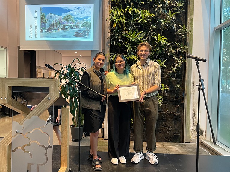 Concordia design student Mélodie Ah-Waye with team members Kamila Nina Andersen and Quentin Meilhon Three young people standing together and holding an award.