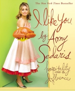 Book cover showing blonde woman in old-fashioned dress and yellow rubber gloves holding a cooked turkey