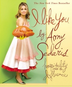 Book cover showing blonde woman in old-fashioned dress and yellow rubber gloves holding a cooked turkey