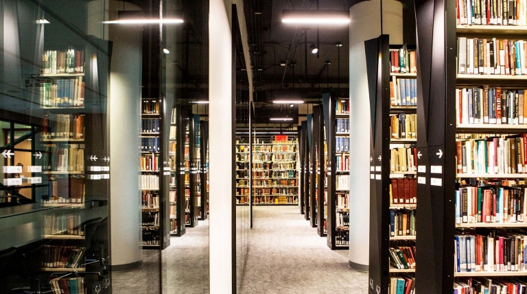 Rows of tall bookcases in a library