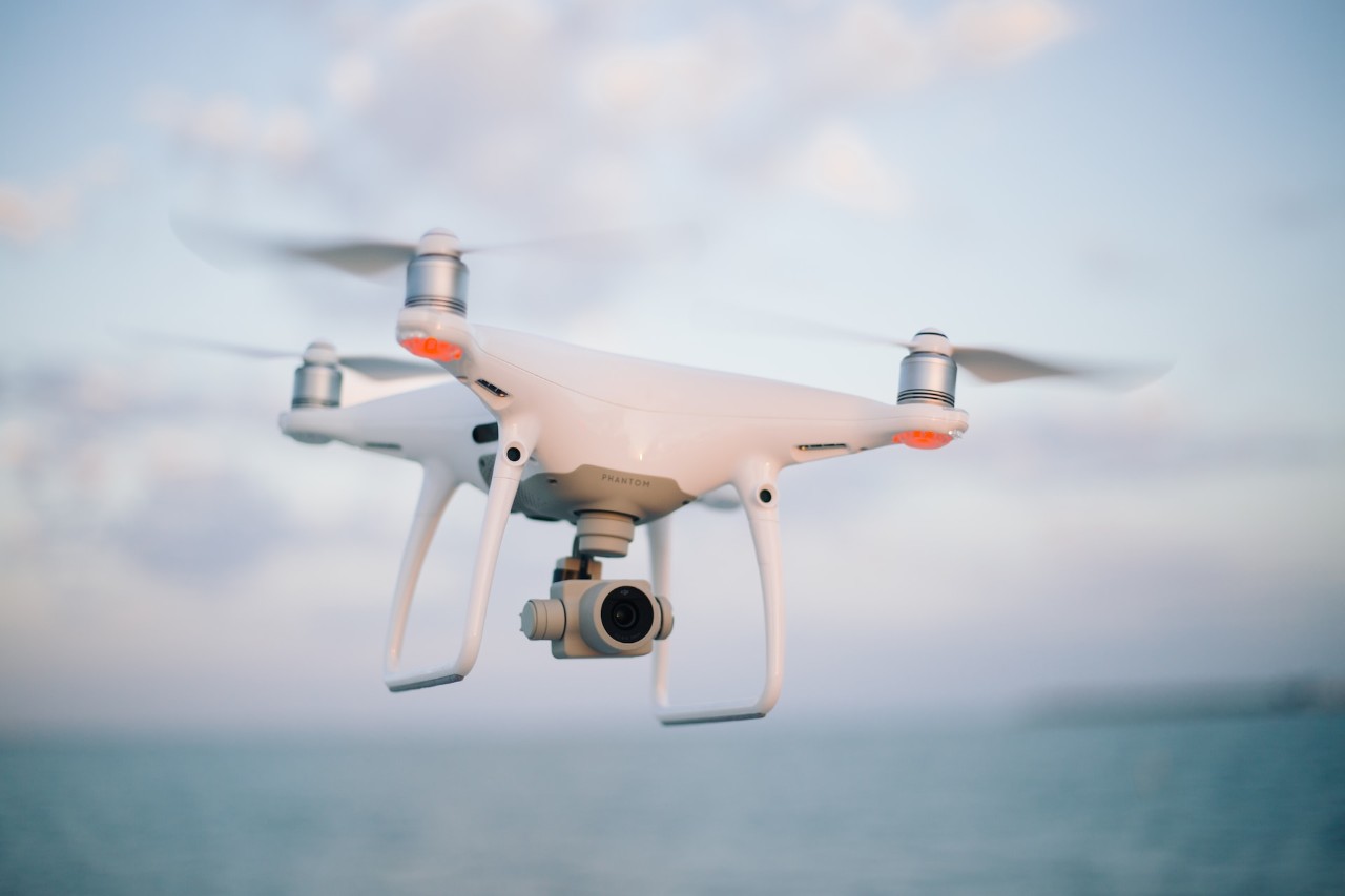 A small electric drone flying in the sky