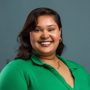 Smiling woman with long dark hair and a green top