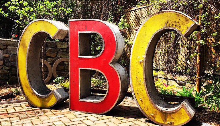 One of the signs donated to the MEM. Photo: Montréal Signs Project Large yellow and red letters in an outdoor setting that spell, "CBC"