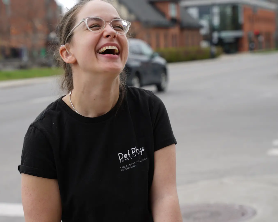 a woman in a black t-shirt laughs