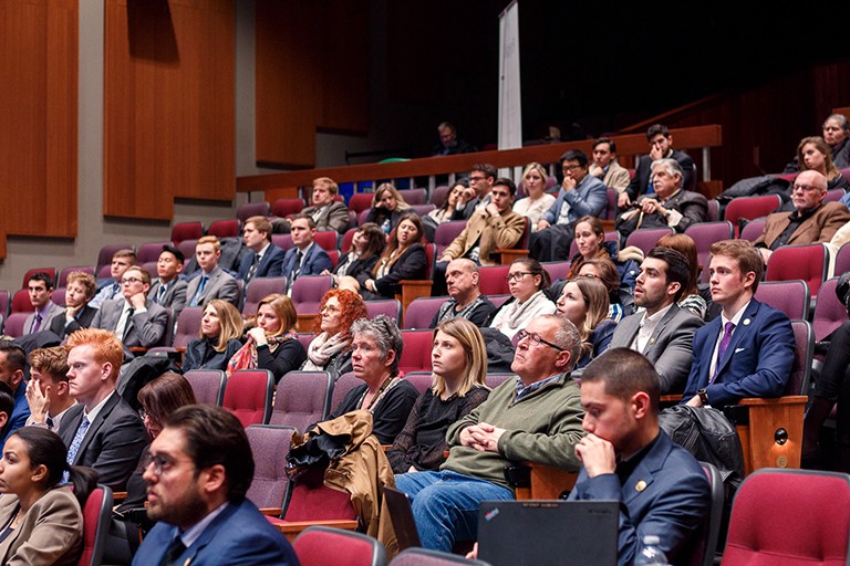 A diverse audience in a auditorium
