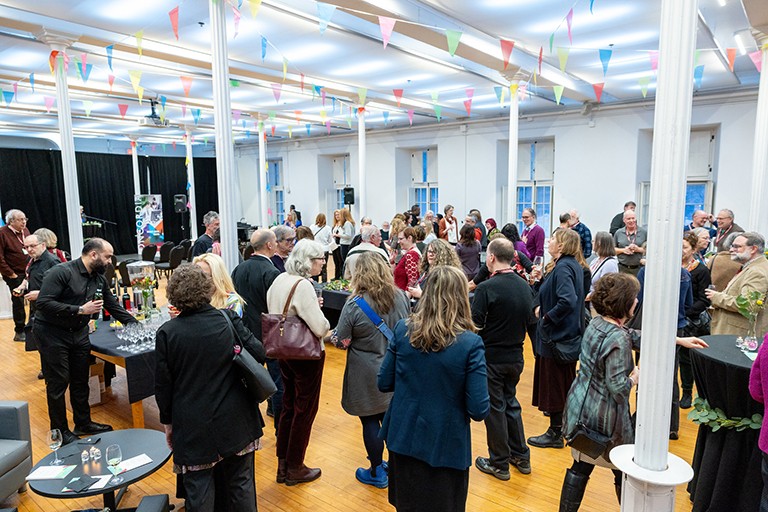 A crowd of people at an event in an interior