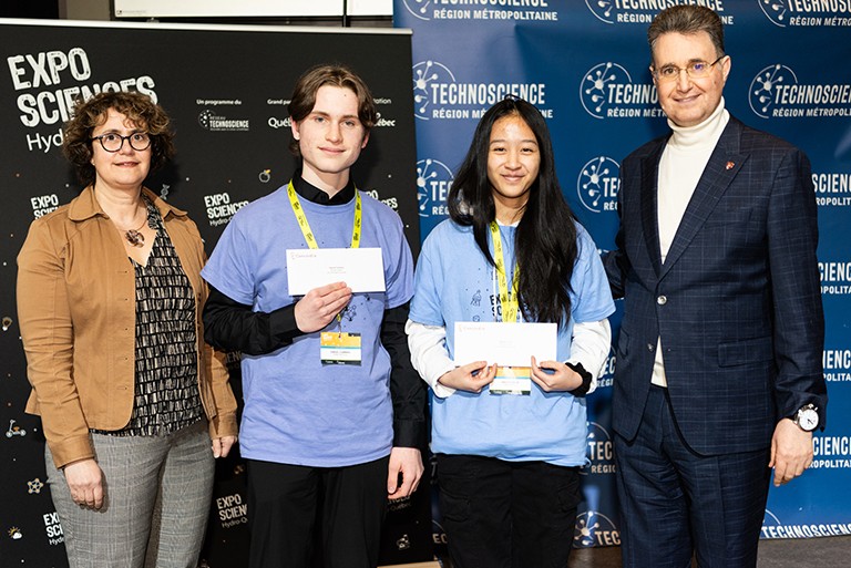From left: Christine DeWolf, Vice-Dean, Faculty of Arts and Science, Samuel Cumming, Bao-Vy Chiem and Mourad Debbabi Dean of the Gina Cody School. Four people (two women and two men) standing in a line and smiling for the camera.