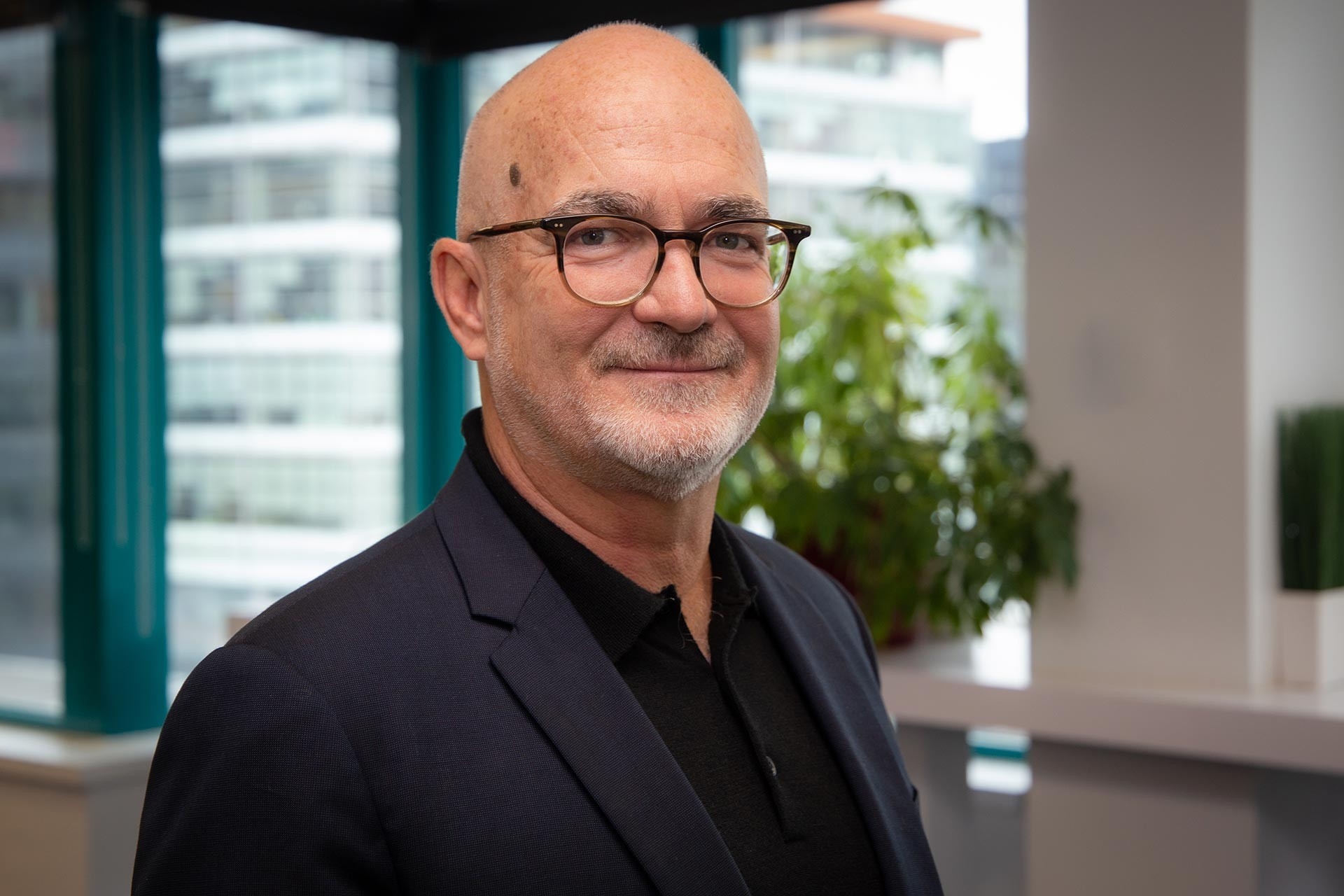 Xavier-Henri Hervé: ‘“I look forward to continuing to collaborate with Concordia.’ Smiling bald man with dark-rimmed glasses, a grey beard, and a black suit.