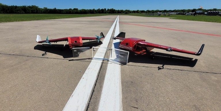 A small model plane coming into land on a runway.