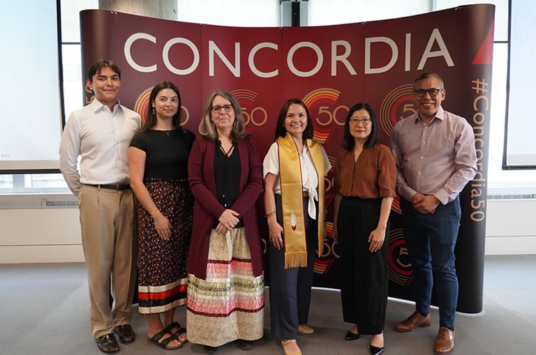 From left: Sebastian Bob, Savannah Matteini-Gabriel, Manon Tremblay, Natasha Ita MacDonald, Bo Kim and Allan Vicaire. A group of people, one of them wearing a convocation sash, standing and smiling for the camera.