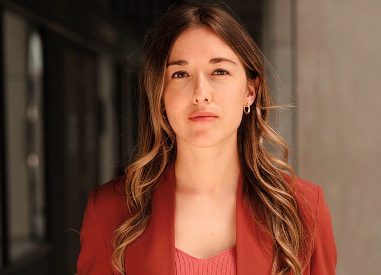 Jessica Bouchard, Vice-President of Public and Economic Affairs and Impact Initiatives at the Chamber of Commerce of Metropolitan Montreal. Young woman with long, blonde hair wearing an orange top and blazer