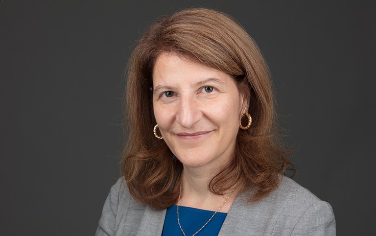 Corinne Gendron, professor at Université du Québec à Montréal. Smiling woman with long brown hair wearing a blue top and grey blazer