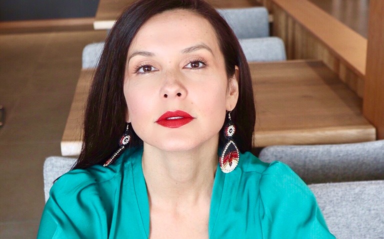 Melina Laboucan-Massimo, founder of Sacred Earth Solar and co-founder of Indigenous Climate Action. | Photo by Nikki Sanchez Young woman with long, dark brown hair, wearing red lipstick and turquoise shirt.