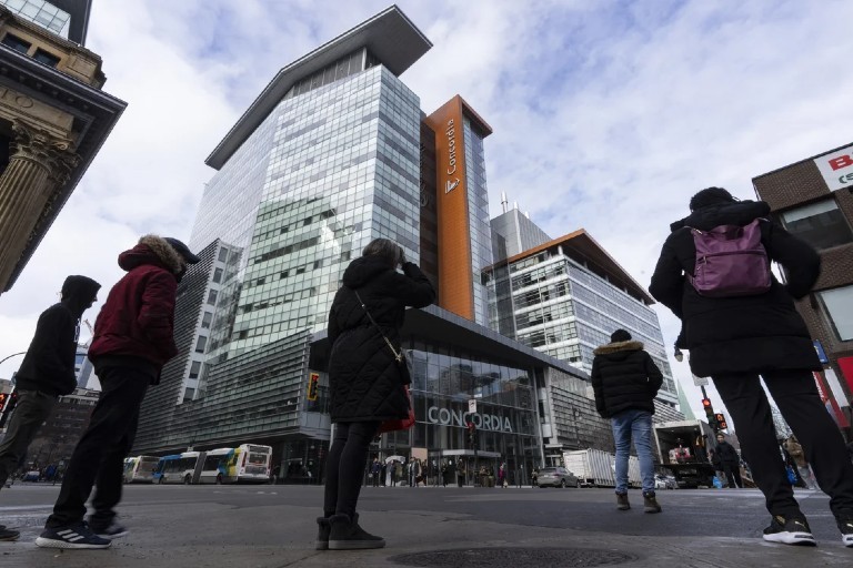 Pedestrians cross the street in front of Concordia’s Engineering, Computer Science and Visual Arts Integrated Complex (EV) on the Sir George Williams Campus in downtown Montreal.