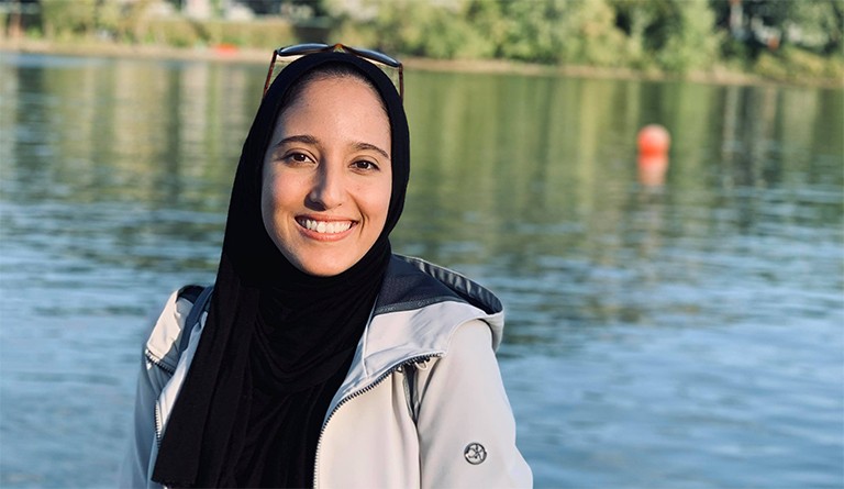 Salma Adem’s study tips include testing your internet connection, avoiding all-nighters and more. Young, smiling woman in a headscarf, with a lake in the background.
