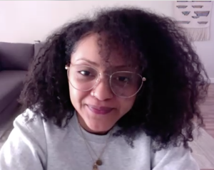 Naya Ali, on a Zoom call, wearing her reading glasses