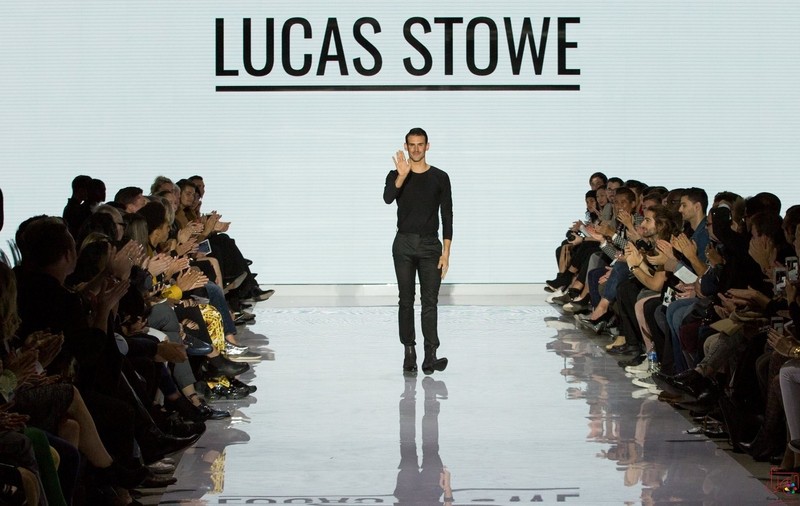 Lucas Stowe walks the runway as the crowd claps