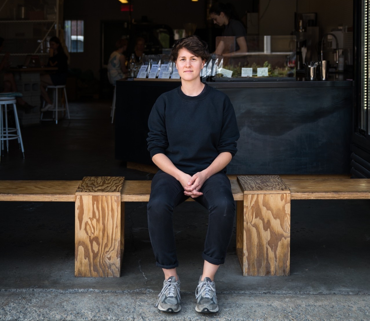 Chrissy Durcak sitting on a bench at a Dispatch location.