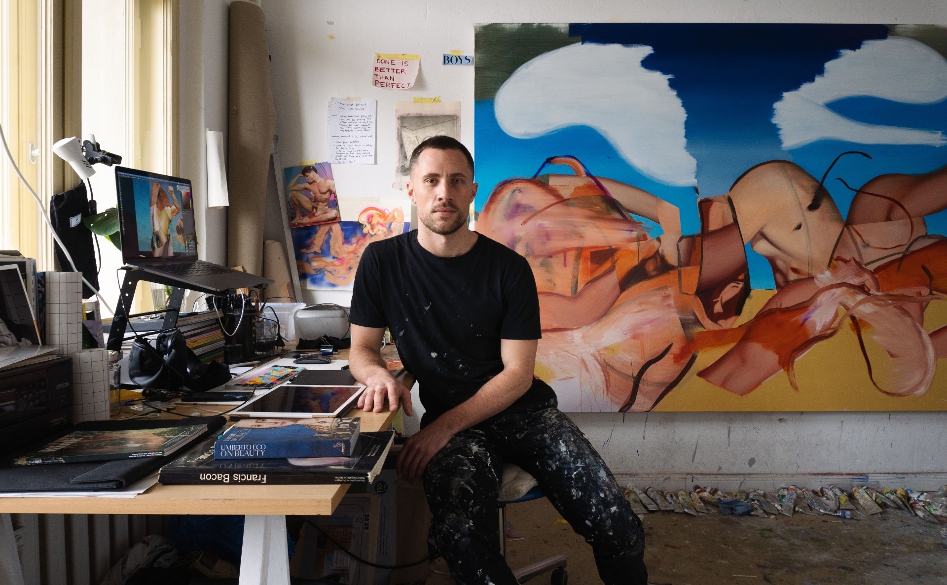 Andrew Moncrief sits as a drawing table in his studio